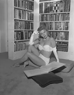 Actress Sally Forrest Posing on Floor Near Bookshelf