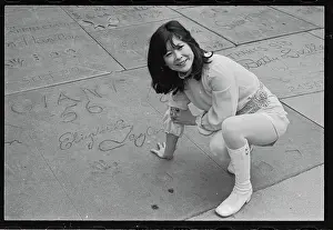 Actress Tsai Chin Stooping and Examining Prints on Hollywood Sidewalk