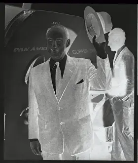 Adlai Stevenson Waving His Hat While Entering Airplane