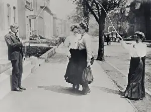 Prints of Adults with jumping rope in street, New York City, New York State, USA A Journey Through Fashion History: Adults with jumping rope in street, New York City, New York State, USA