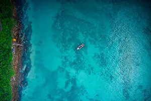Aerial view of boat on crystal clear water in Phi Phi Island, Krabi, Thailand