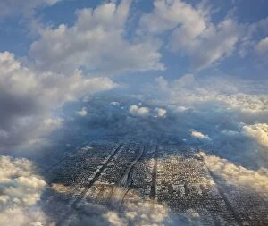 Aerial view of cityscape under clouds