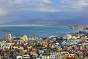 Cathedral Gallery: Aerial view over downtown Reykjavik with ocean and mountain at back, Iceland