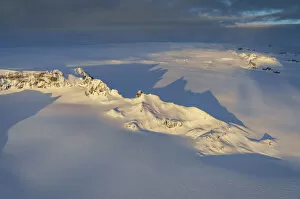 Deep Snow Collection: Aerial view of mountains and cliffs on a glacier, Iceland