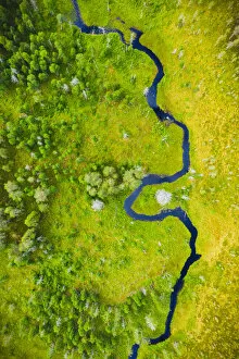 Aerial Art Gallery: Aerial view of a small river flowing through marshland in Finland