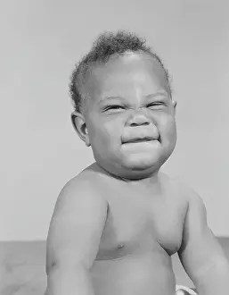 Candidate Terms Prints: African-American baby squinting eyes and scrunching up face