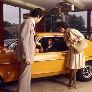 Consumerism Prints: African-American Couple Buy New Orange Car From A Salesman At Automobile Dealer Showroom