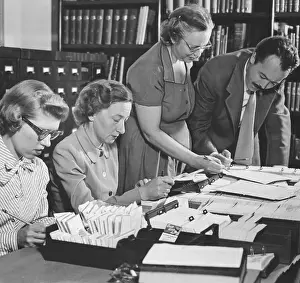Aides Looking Through Material