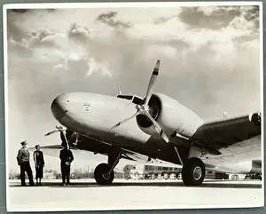 Airline Employees Standing Below Airplane