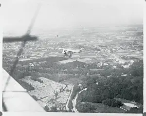 Brussels Prints: Airplane Flying Over Landscape