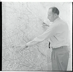 Airport Official Pointing to a Map