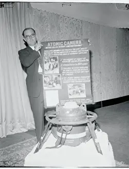 A.L. Dowling Posing Next to Atomic Camera