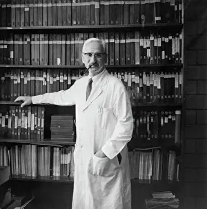 Albert Sabin Posing with Books Containing Research