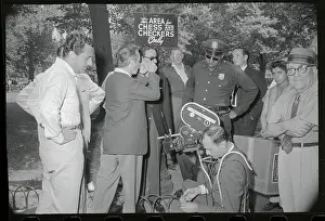 Prints of (Original Caption). New York: Alberto Sordi, Italy's favorite comedian (left) finds little to laugh about Aug. 3 as a policeman halts television interview he was giving in Washington Square Park Timeless Comedy Icons: Classic Moments from the Legendary Duo: Alberto Sordi Interviewing in New York