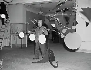 Alexander Calder Posing with One of His Sculptures