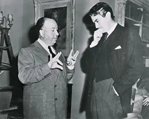 Hand On Chin Prints: Alfred Hitchcock Conversing with Gregory Peck