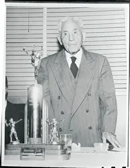 Stockton Prints: Alonzo Stagg Standing Near Large Trophy