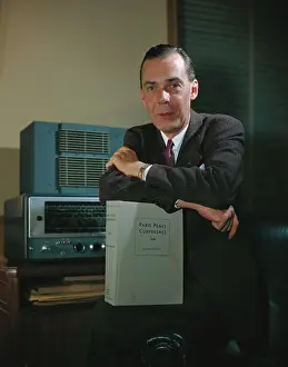 Ambassador Prints: Ambassador George Allen Leaning on Conference Manual