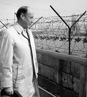 Prints of US Ambassador to the United Nations Adlai Stevenson inspects a section of the Berlin Wall during a visit to the divided city, Berlin, Germany, May 1963. (Photo by PhotoQuest/Getty Images) Berlin Wall (Antifascistischer Schutzwall) Prints: Ambassador Stevenson At The Berlin Wall