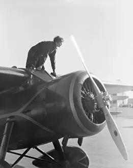 Amelia Earhart On Top Of Her Plane