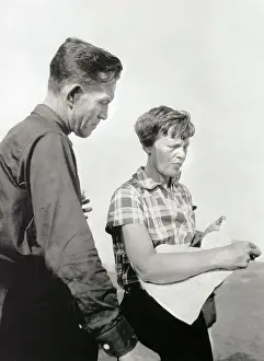 Amelia Earhart Putnam and Fred Noonan Looking over Map