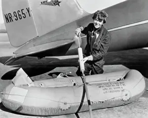 Amelia Earhart Working on Raft Besides Airplane