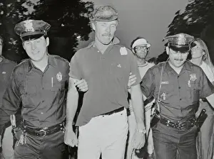 American Cup Winner Ted Turner Being Escorted by Policemen