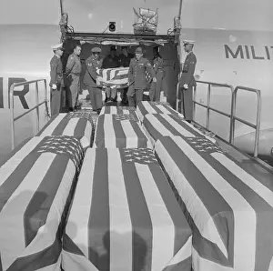 Loss Prints: American Flag Covered Caskets Being Unloaded from Airplane