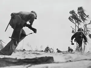 American Marines Crossing Terrain Hastily with Tools in Hand