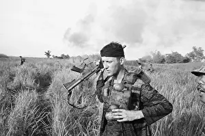 American Soldier Carrying Grenades and Gun