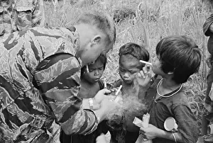 American Soldier Lighting Cigarettes for Montagnard Children