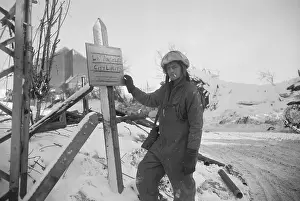Unpaved Road Prints: American Soldier Writing on Sign in Belgium