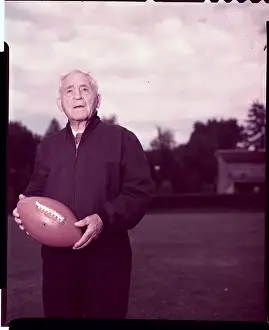 Amos Alonzo Stagg Sr. Holding Football