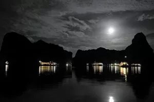 Anchored Junk boats in Halong Bay at night