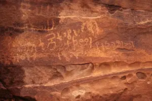 Language Prints: Ancient Nabatean Petroglyphs rock engravings in Wadi Rum desert Jordan