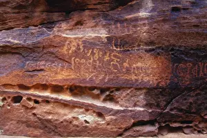 Language Prints: Ancient Nabatean Petroglyphs rock engravings in Wadi Rum desert Jordan