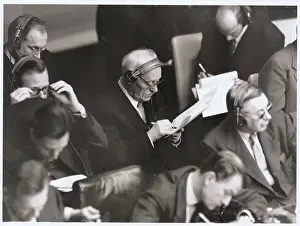 Andrei Vishinsky with Earphones and Writing on Document