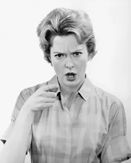 Angry woman in studio, (B&W), (Portrait)
