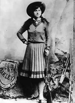 Prints of US rodeo star Annie Oakley (1860 - 1926), who was famous as a highly skilled trick shooter with the Buffalo Bill Wild West Show. One of her tricks was to shoot cigarettes from her husbands mouth The Keystone Press Agency Collection Prints: Annie Oakley
