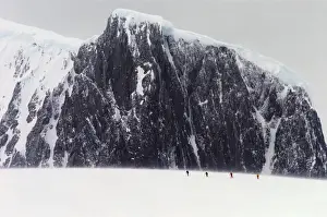 Rock Face Prints: Antarctica, Palmer Peninsula, climbers skiing towards mountain, summer