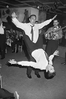 Anthony Quinn Dancing with Man Around Waist