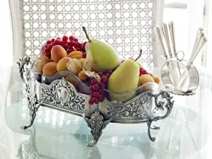 Stylish Prints: Antique silver fruit bowl with fruit in a sophisticated atmosphere on a breakfast table