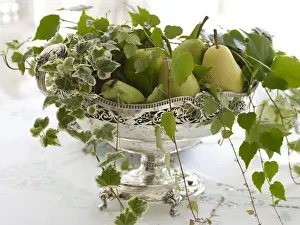 Stylish Prints: Antique silver fruit bowl with pears and stylish decoration in a noble ambiance