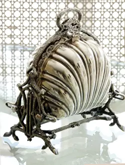Stylish Prints: Antique silver hinged bread basket in a sophisticated atmosphere