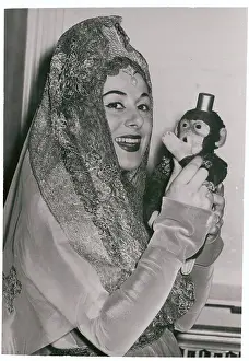 Antonietta Stella Holding Toy Monkey