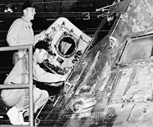 Apollo 13 astronauts Swigert and Lovell look over command module