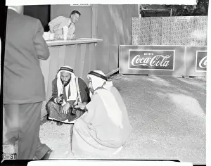 Arab Men Sitting on Floor Drinking Soda Pop