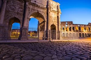 The Arch of Constantine and Colosseum at sunrise in Rome, Italy