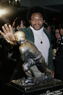 Archie Griffin Posing With Heisman Trophy