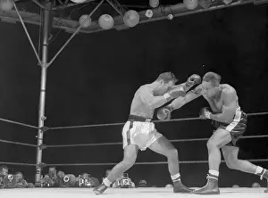 Photojournalist Prints: Archie Moore Punching Rocky Marciano